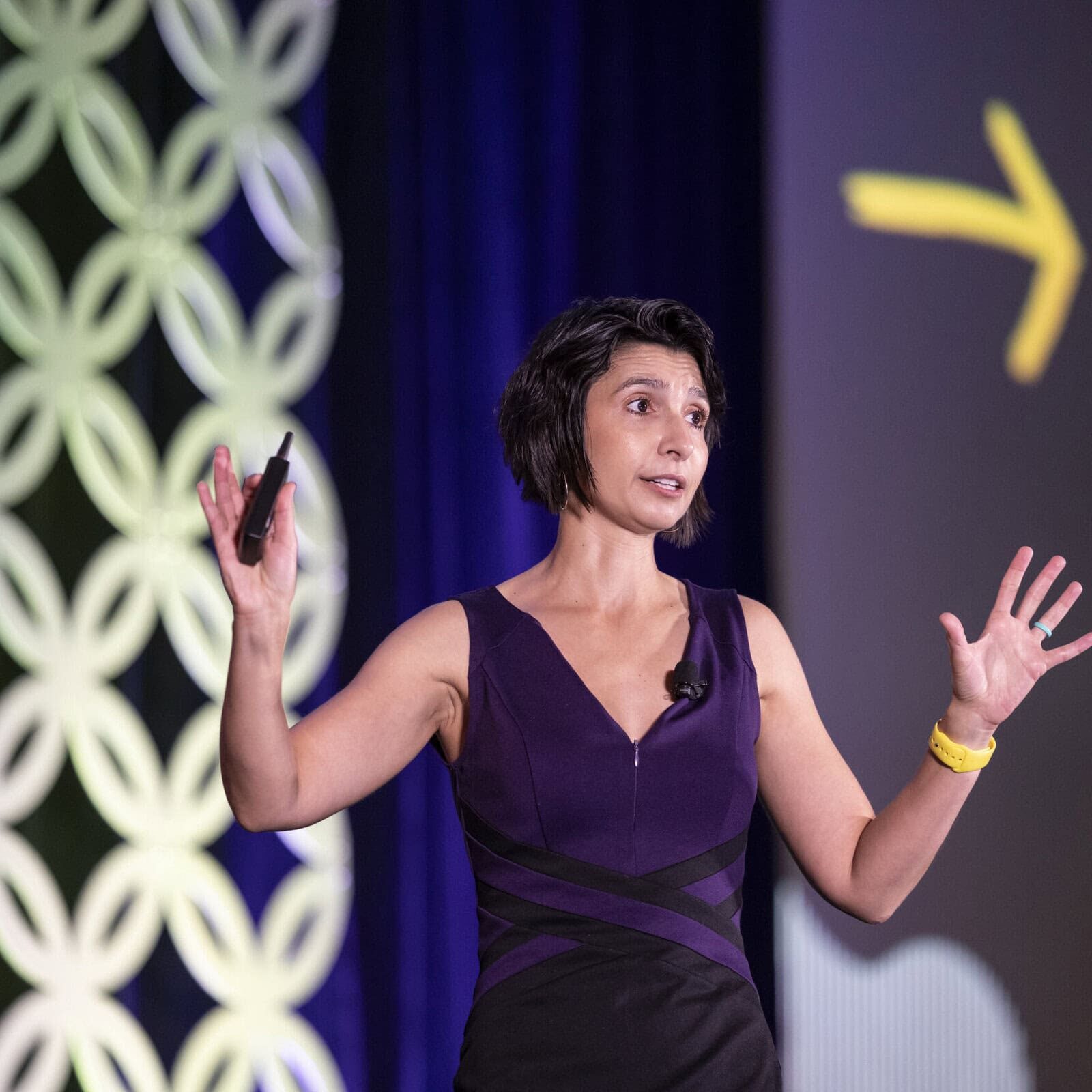 Keynote speaker presenting on stage at an ICF Conference, discussing the future of coaching.