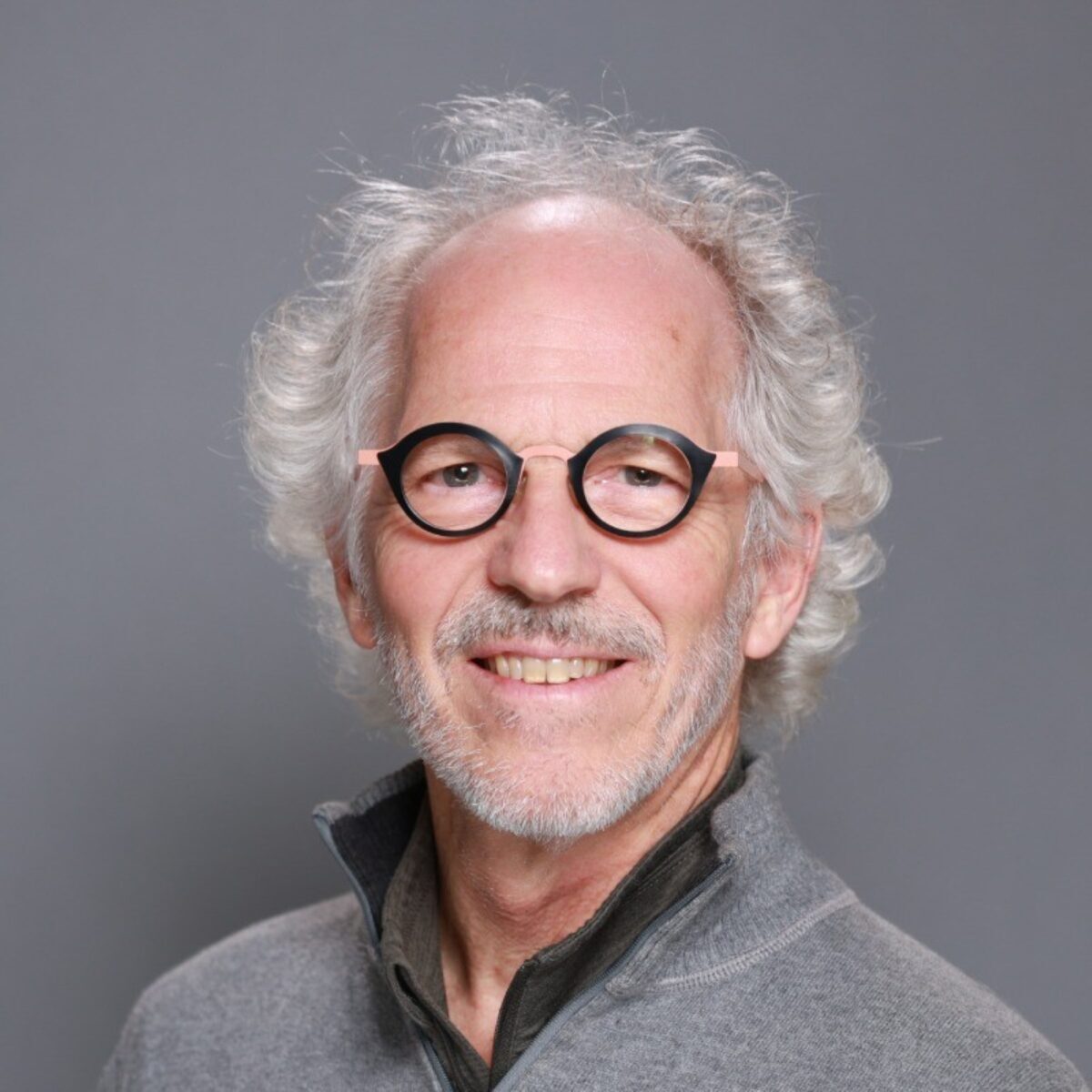 Joel DiGirolamo is the vice president of research and data science for ICF, headshot is of a man smiling with glasses on wearing a gray shirt in front of a gray background