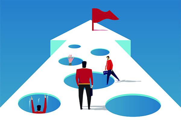 arrow pathway with holes and a red finish flag at the end one person standing ready to navigate while others have fallen into some holes